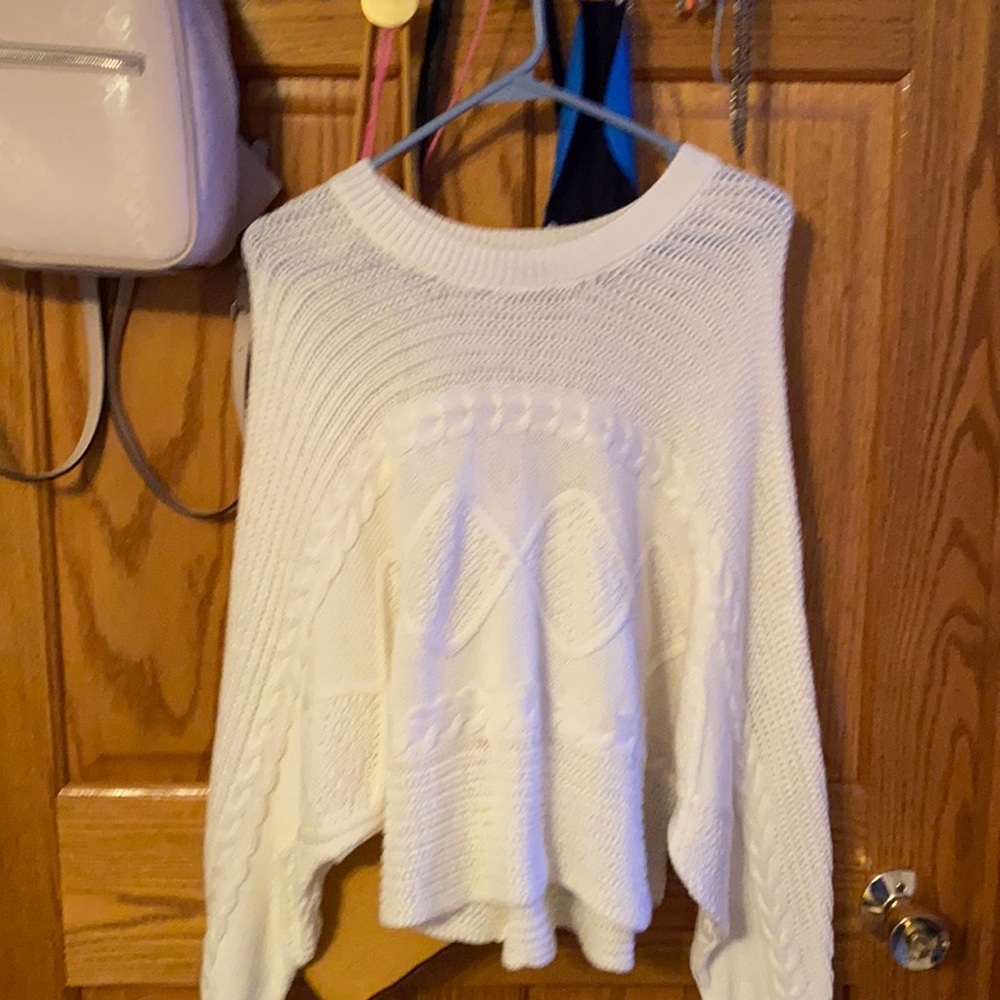 white sweater with tags